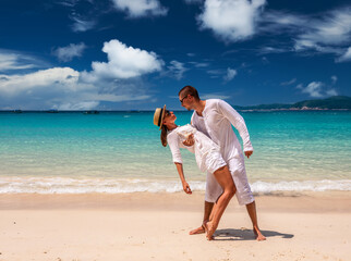 Couple in white having fun on a beach