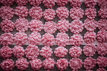 Fototapeta na wymiar full frame shot of crocheted flowers on wall