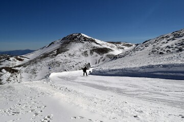 Ski trail in a ski resort and skier