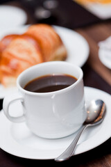A cup of coffee and bun