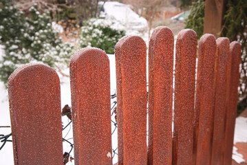 A frosted, wooden wicket in the garden in the winter