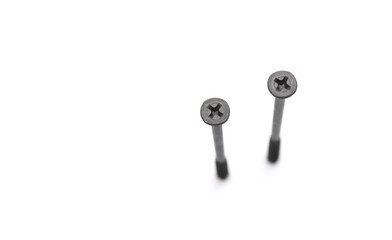 metal screws with long dark thread on white background