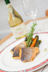 Sea bass and white wine, dinner in restaurant
