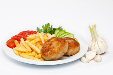 Cutlet and french fries on white plate