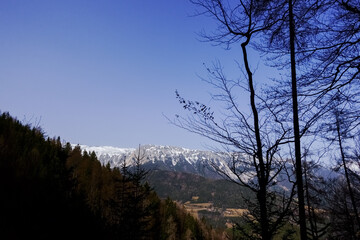 view to high mountains with snow on the horizon
