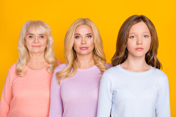 Photo of nice three woman grand mom daughter look same wear pastel cloth isolated on yellow color background