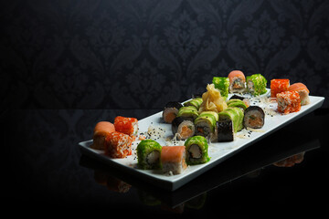 Different types of sushi and rolls in restaurant