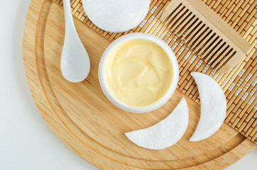Yellow facial mask (banana face cream, shea butter hair mask, body butter) in the small white jar....