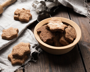 baked star shaped gingerbread cookies on a wooden table,