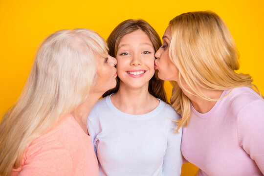 Photo Of Optimistic Three Woman Grand Mom Daughter Kiss Wear Pastel Cloth Isolated On Yellow Background