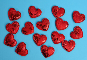 Fototapeta premium red textile small hearts on blue background, festive background