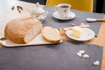 fresh loaf of bread lying on linen towel on wooden table