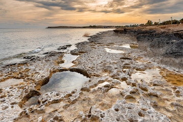 Seascape of Cyprus stone coast at sunset
