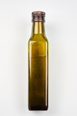 Green transparent glass bottle of olive oil.