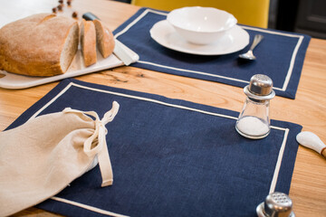 fresh loaf of bread lying on linen towel on wooden table