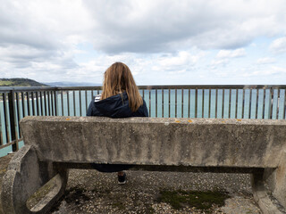 woman sitting on the pier