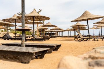 The big empty sandy beach with umbrellas