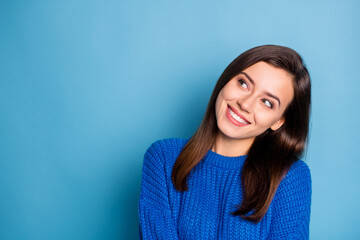 Fototapeta premium Portrait of young beautiful cheerful happy positive girl smiling looking copyspace isolated on blue color background