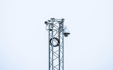 Security camera mast with equipment to provide surveillance and security of a local area.