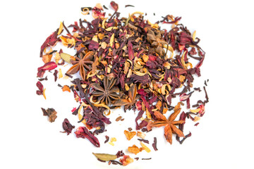 Heap of dry herbal tea with spices and fruits (hibiscus, star anise and other) on white background