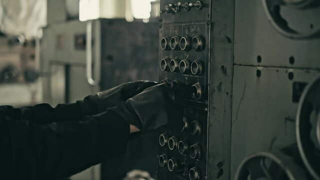 STACK OF FOOTAGE: Gloved hand of a worker presses buttons on the control panel. Cinematic shot