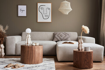 Interior design of cozy living room with stylish sofa, coffee table, dired flowers in vase, mock up poster, carpet, decoration, pillows, plaid and personal accessories in modern home decor. Template.
