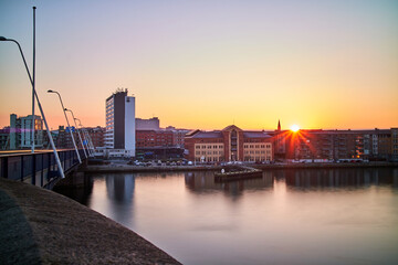 city view with sunset and a bridge and buildings