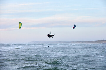 kite surfing on the water in the ocean and flying