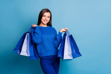 Photo of young happy positive good mood girl smiling hold shopping bags on black friday isolated on...