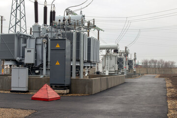 High voltage transformers in an electrical substation. Side view. Selective focus.