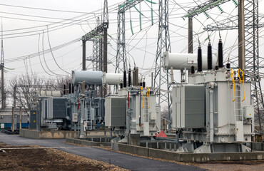 Fototapeta na wymiar High voltage transformers at a power substation. High voltage. High voltage power transformer substation