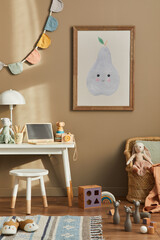 Interior design of stylish kid room space with white desk, wooden laptop, toys, child accessories, lamp, cozy decoration and hanging cotton flags on the beige wall.  Mock up poster frame. Template.