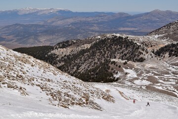 Ski trail in a ski resort and skier