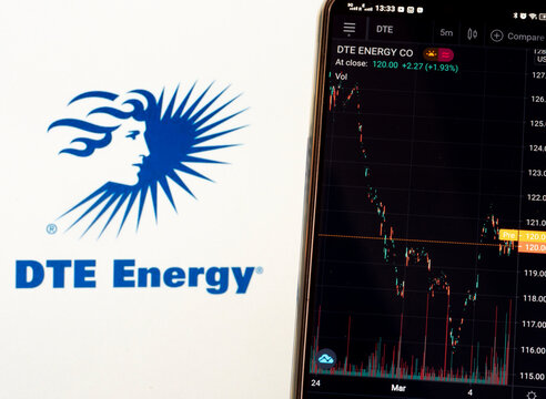 In this photo illustration the stock market information of DTE Energy Co. displays on a smartphone while the logo of DTE Energy Co. displays as the background
