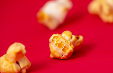 Close-up of popcorn on a red background.