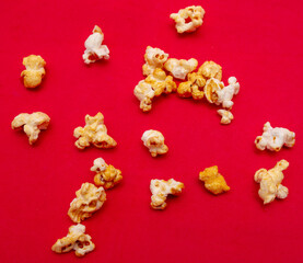 Close-up of popcorn on a red background.