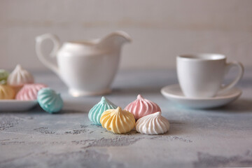Romantic Breakfast with meringue cookies, white cups and creamer