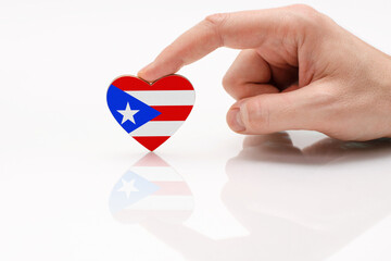 Puerto Rico flag. Love and respect Puerto Rico. A man's hand holds a heart in the shape of the...