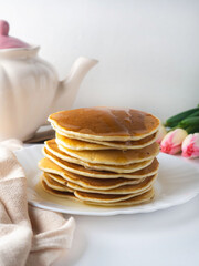 A stack of pancakes with honey
