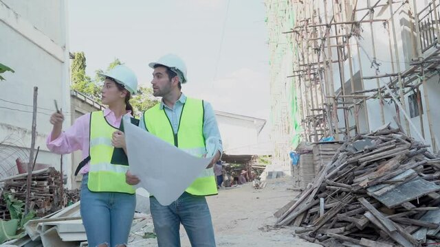 eam of young caucasian man contractor, woman engineering, partner explain and inspect the construction and renovation, check defect of building, apartment or home. Engineer, architect worker concept.