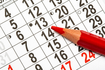 Monthly calendar and a red pencil