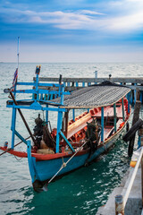 an asian adult standing on his fishing boat to start work day on morning at the island driving for people as a taxi