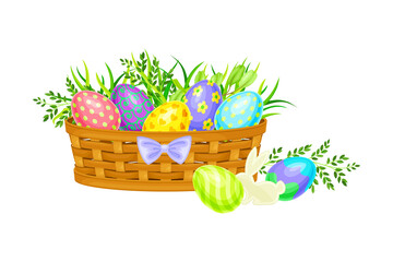 Painted or Foiled Easter Eggs or Paschal Eggs Rested in Wicker Basket in Green Grass Vector Illustration