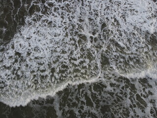 sunset in the atlantic ocean coast of argentina monte hermoso. waves with foam and beautiful sky colors