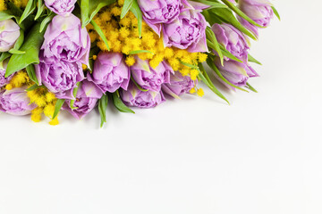 Bouquet of lilac Double Flag tulips, yellow mimosas on white background, copy space, side view, closeup. March 8, February 14, birthday, Valentine's, Mother's, Women's day celebration, spring concept