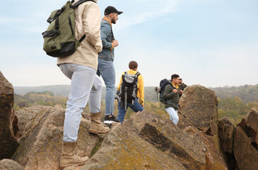 Group of hikers with backpacks at top of mountain