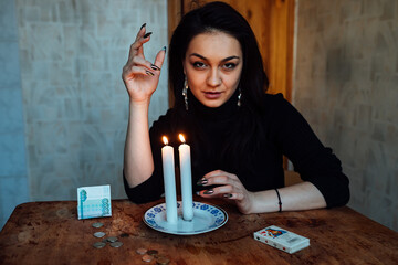 a fortune teller looks at a candle flame, a magical ritual for predicting the future