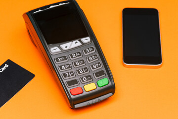 Pay for purchases with a mobile phone or credit card using a POS terminal. E-commerce. Business and technology