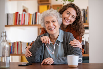 Happy granddaughter embracing senior grandmother