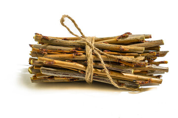 a bundle of twigs tied with a hemp rope on a white background